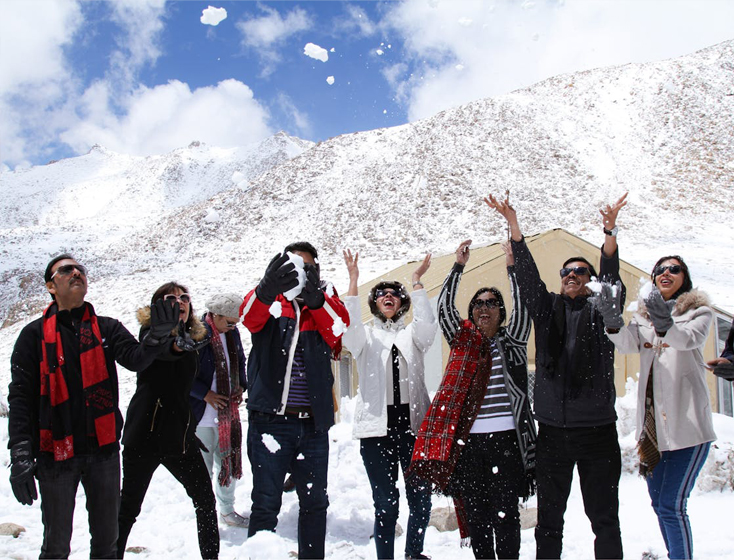Happy group with ski and snowboard gear ready for a Mt Buller snow trip